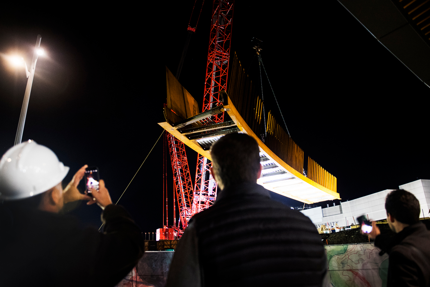 people watch ISEC Pedestrian Bridge installation
