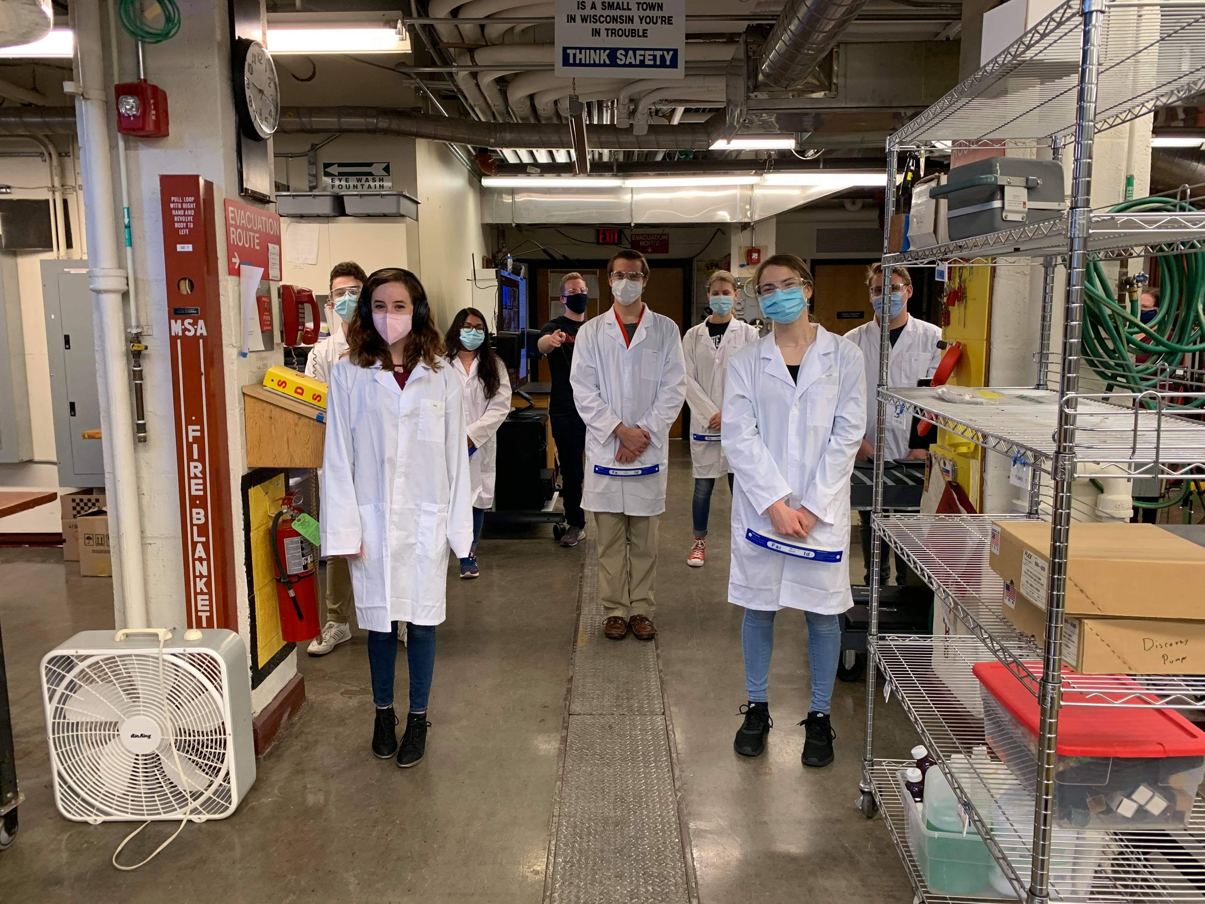 chemical engineering students in lab posing for photo