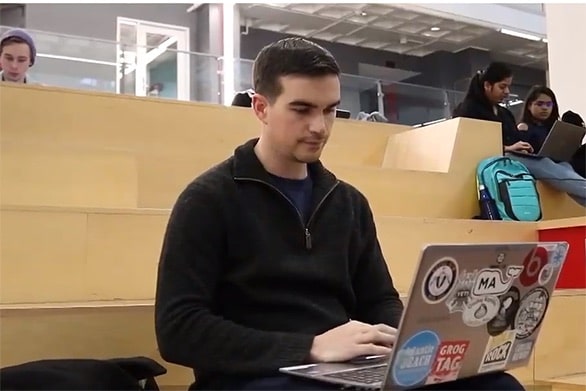 James Meyers sitting with a laptop