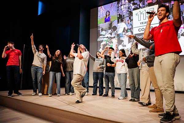 students on stage singing