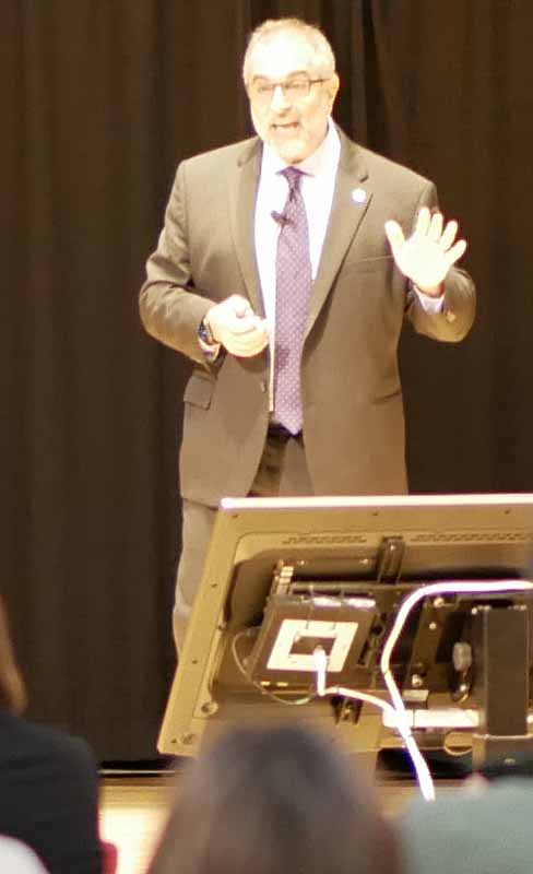 dean presenting at podium