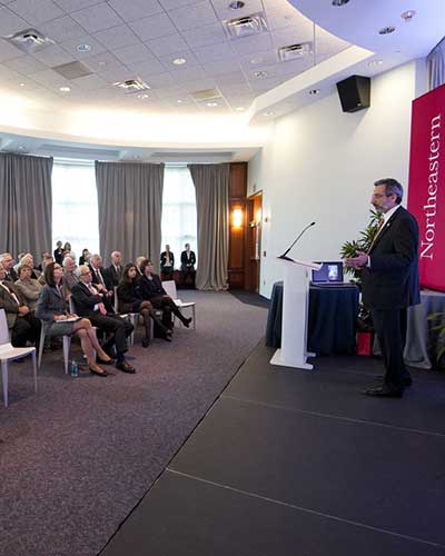 dean presenting at podium