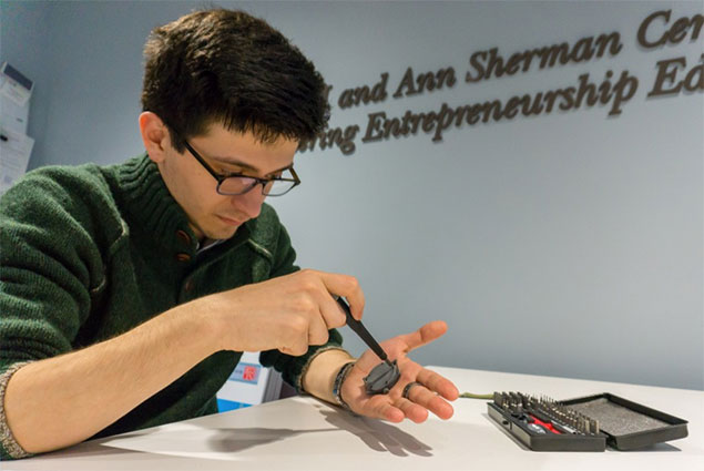 student working in the Sherman Center on his watch invention