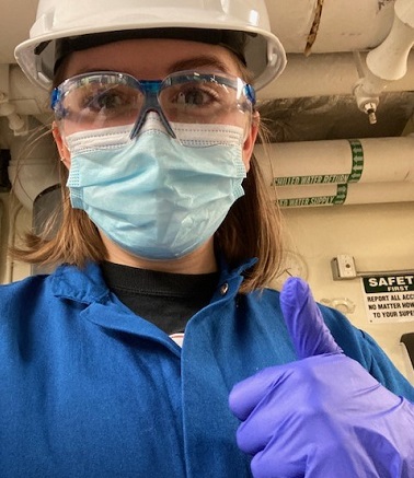 student in lab coat gloves and mask