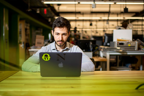 student sitting in lab working on laptop