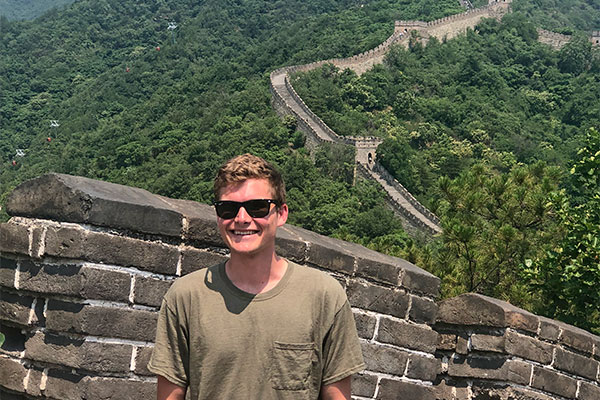 student with Great Wall of China in background