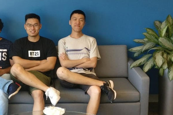 two students sit on couch on co-op at Philips