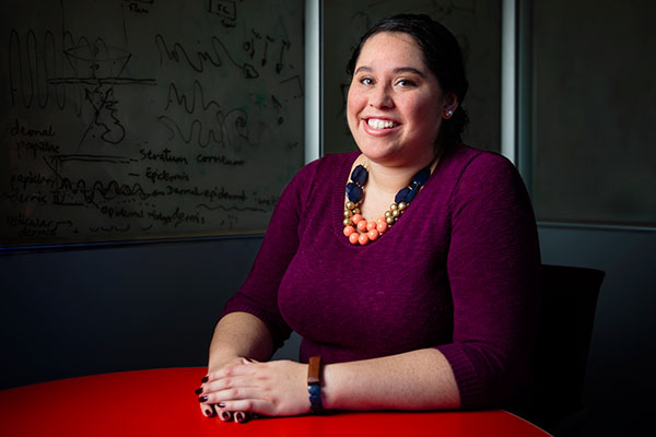 student sitting at table smiling