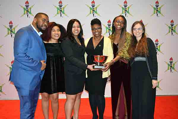 student group accepting award at conference