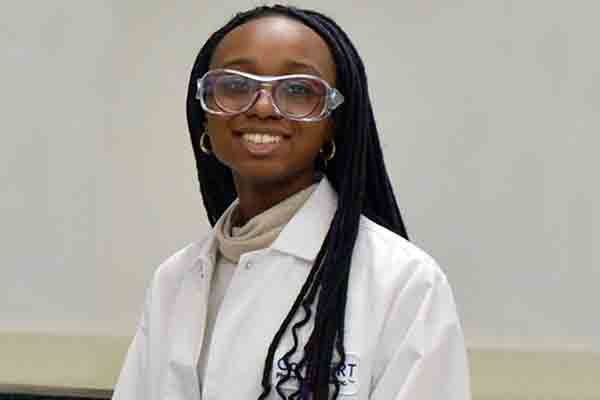 student in lab coat while on co-op