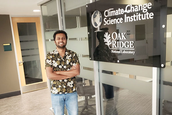 student standing next to Oak Ridge National Lab sign while on co-op