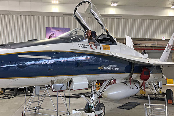 student at NASA sitting in plane