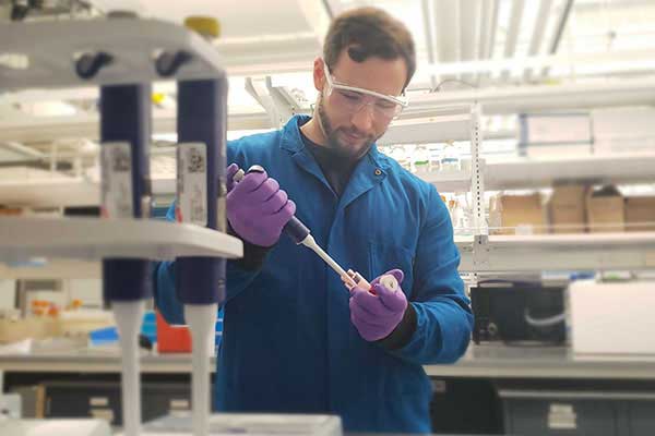 doctoral student working in chemical engineering lab