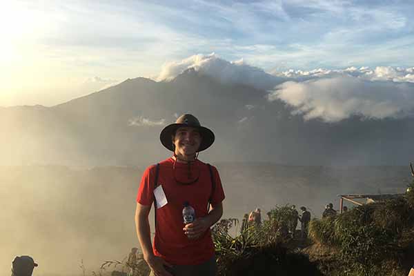 student with mountains in background