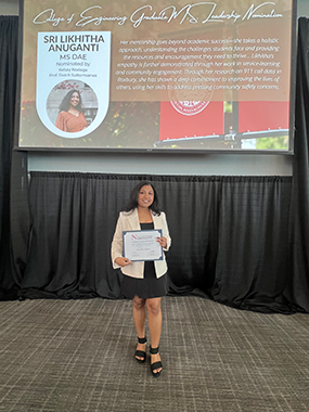 student, anuganti, standing with an award