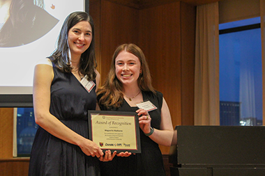 Maguerite Matherne posing with a student holding her award