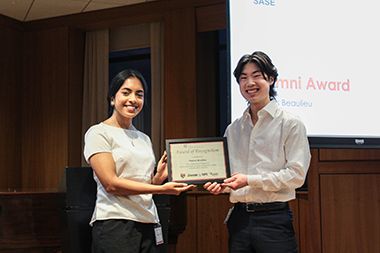Thomas Beaulieu standing to the right of a student holding an award