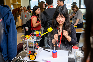 student looking at project at the fye london expo