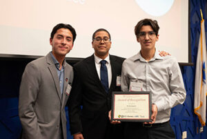 Jose Meza LIamosas standing with two others at the Annual Recognition Banquet