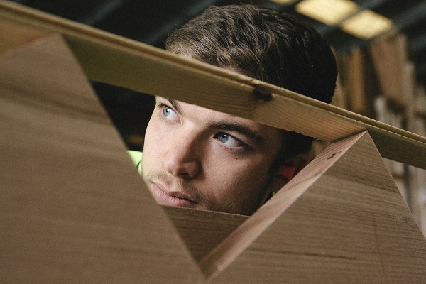 student looking through stair case section while building