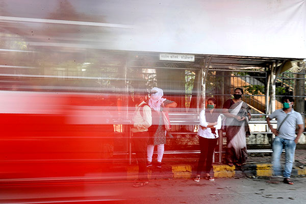 abstract photo of people in India on street sidewalk with masks on