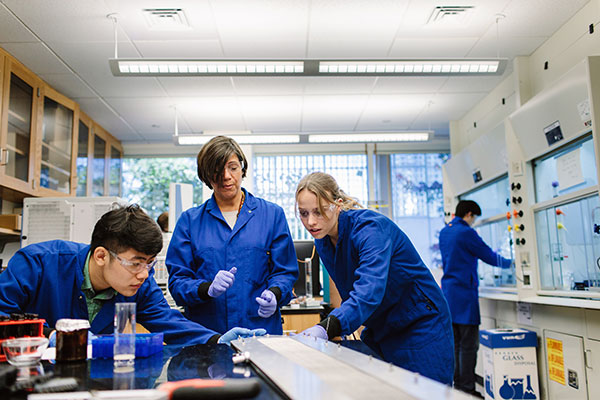 professor with students in environmental lab