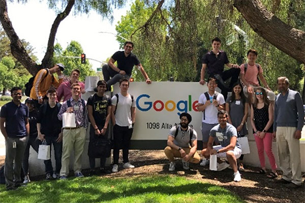 students in front of google sign