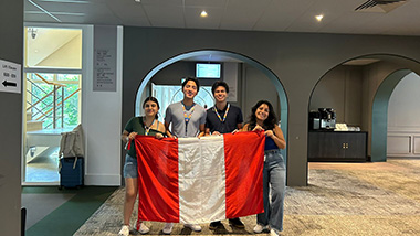 Jose Meza LIamosas holing the flag of Peru with 3 other people