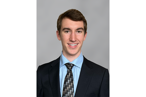 Matthew Coughlin headshot with a grey background