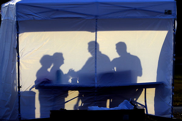 silouette of medical workers in a medical tent