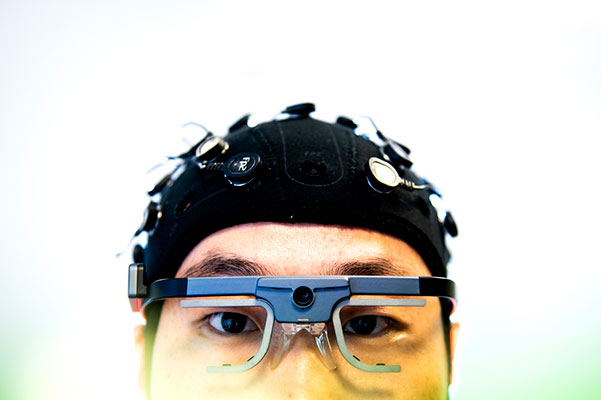 top half of head with cap on and lab glasses as part of testing for pain research