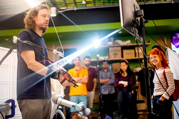 Peter Whitney, professor of engineering, demonstrates robotic teleoperation with haptic feedback.