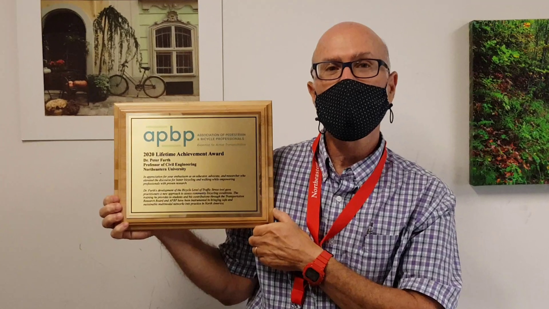 professor showing apbp award certificate