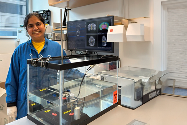 female student in bioengineering lab with fish-tank-like experiment