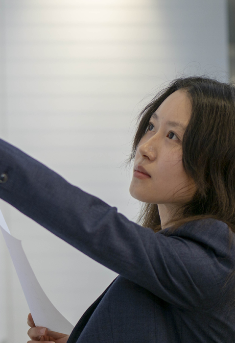 woman pointing at board with data